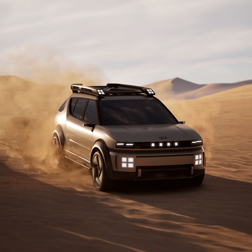 A futuristic SUV driving through desert sand, showcasing off-road capability.