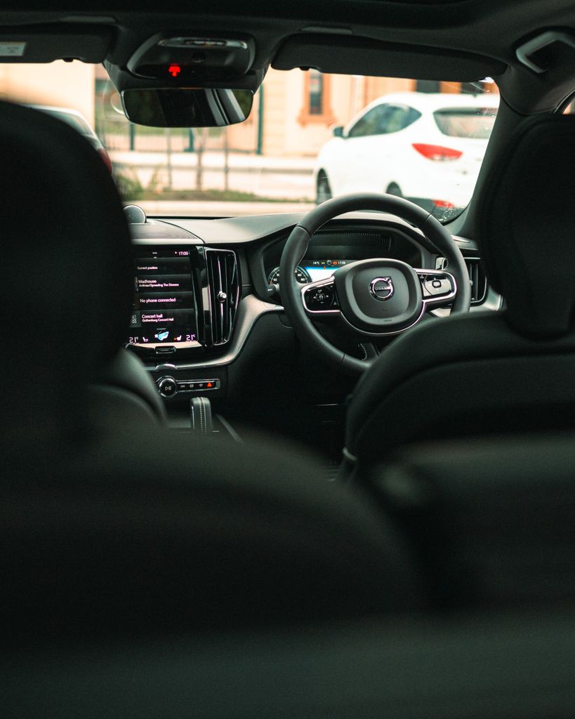A vertical shot highlighting the elegant interior and steering of a Volvo XC60. Ideal for automotive enthusiasts.
