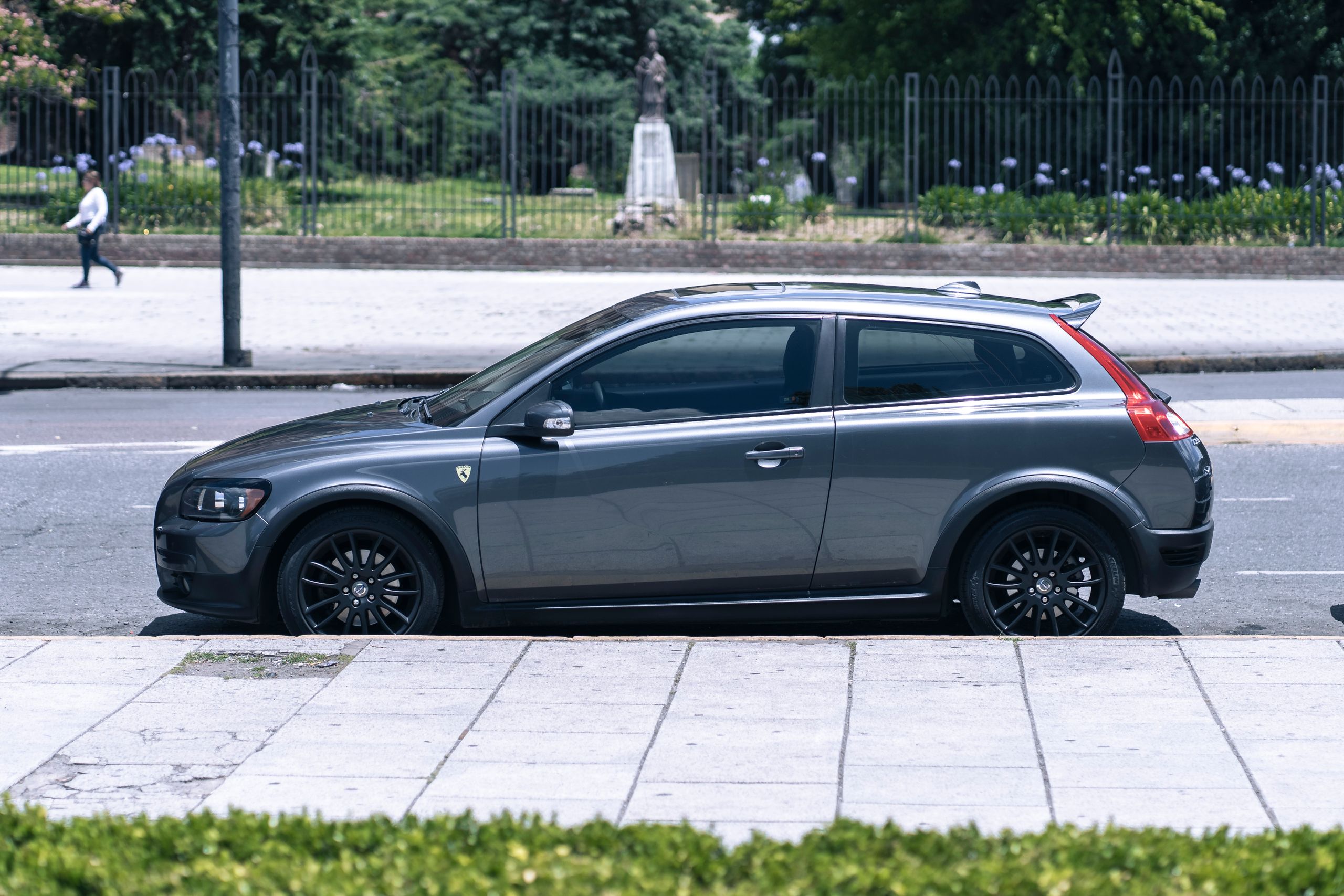 Captivating image of a grey compact car parked alongside a city street, perfect for urban lifestyle themes.