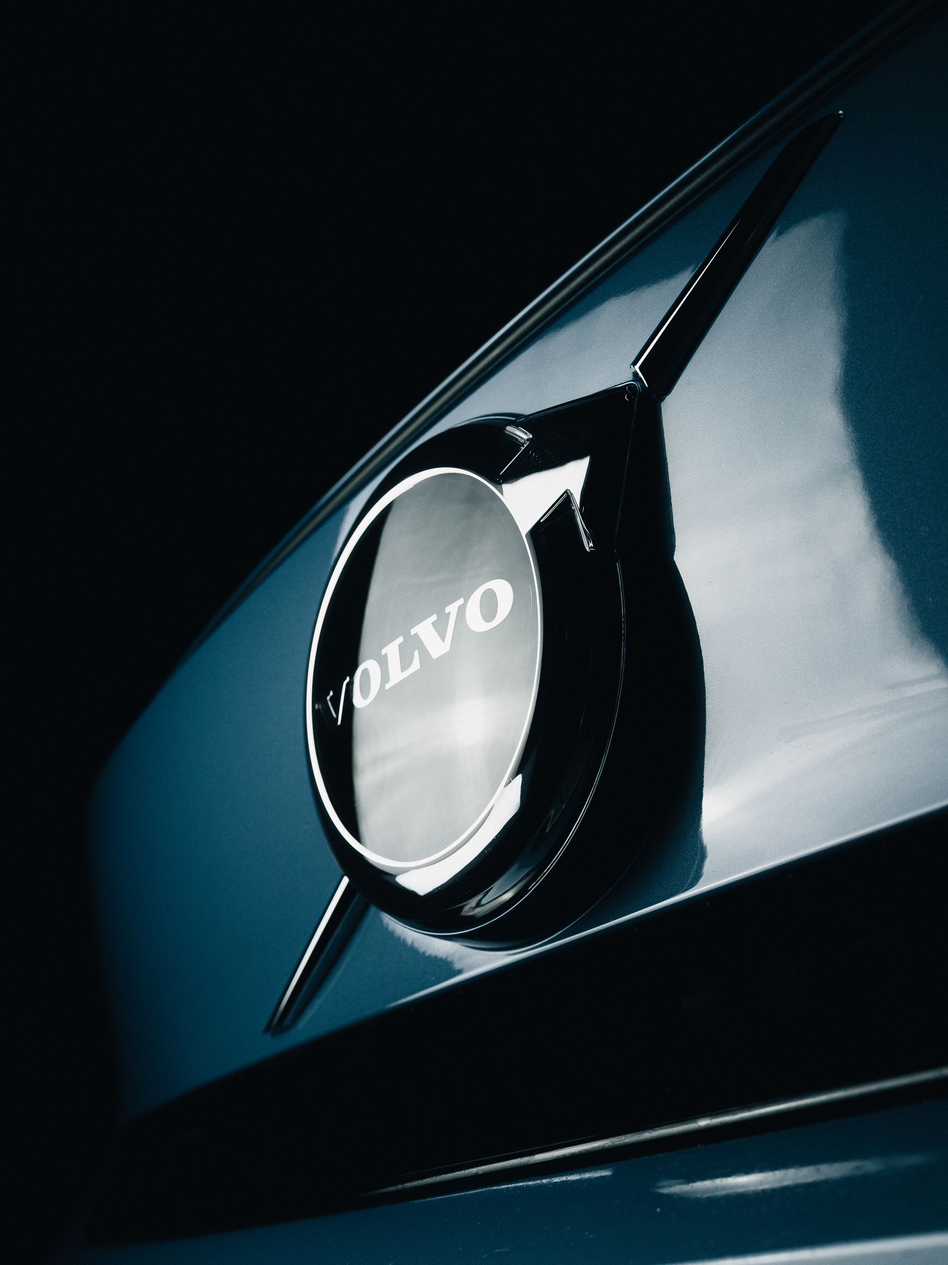 Detailed shot of a shiny Volvo car emblem with selective focus, captured outdoors in Curitiba, Brazil.