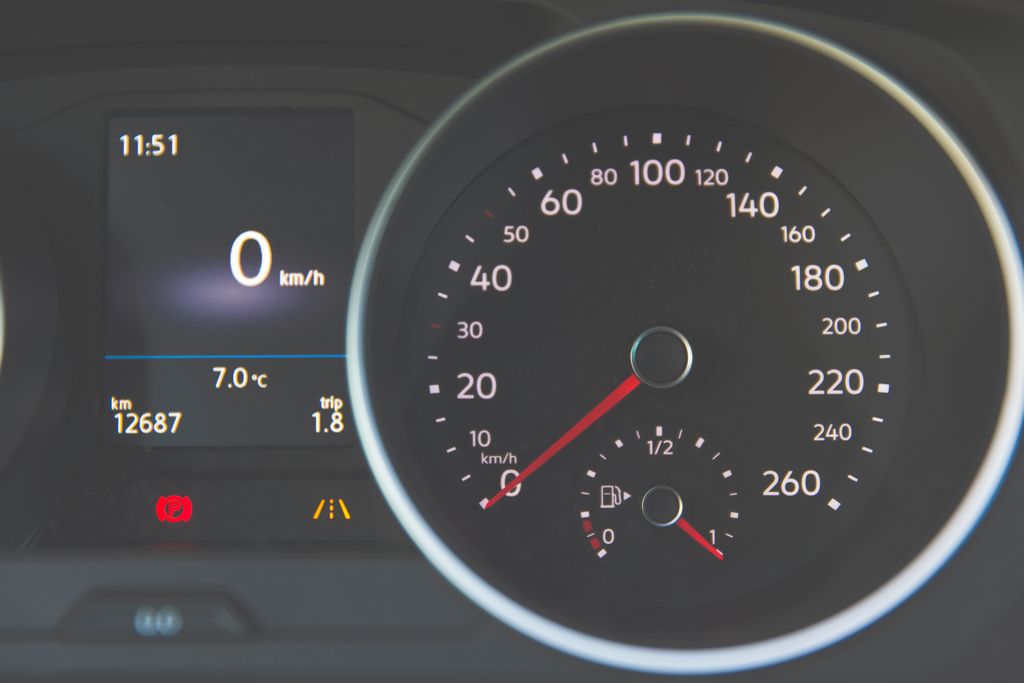 How to Change MPH to KM/H on a Volvo XC60? Detailed view of a car speedometer showing 0 km/h and fuel gauge with digital display.
